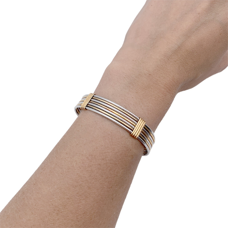 Bracelet Cartier or jaune et acier.