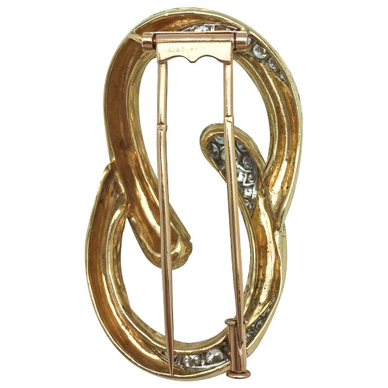 Broche Mauboussin "Boucle" en or jaune et platine, diamants.