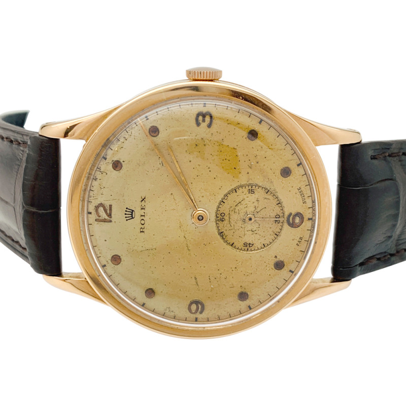 Montre Rolex en or rose, bracelet cuir.