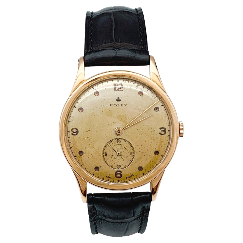 Montre Rolex en or rose, bracelet cuir.