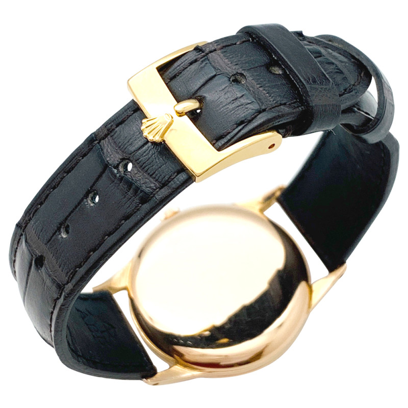 Montre Rolex en or rose, bracelet cuir.